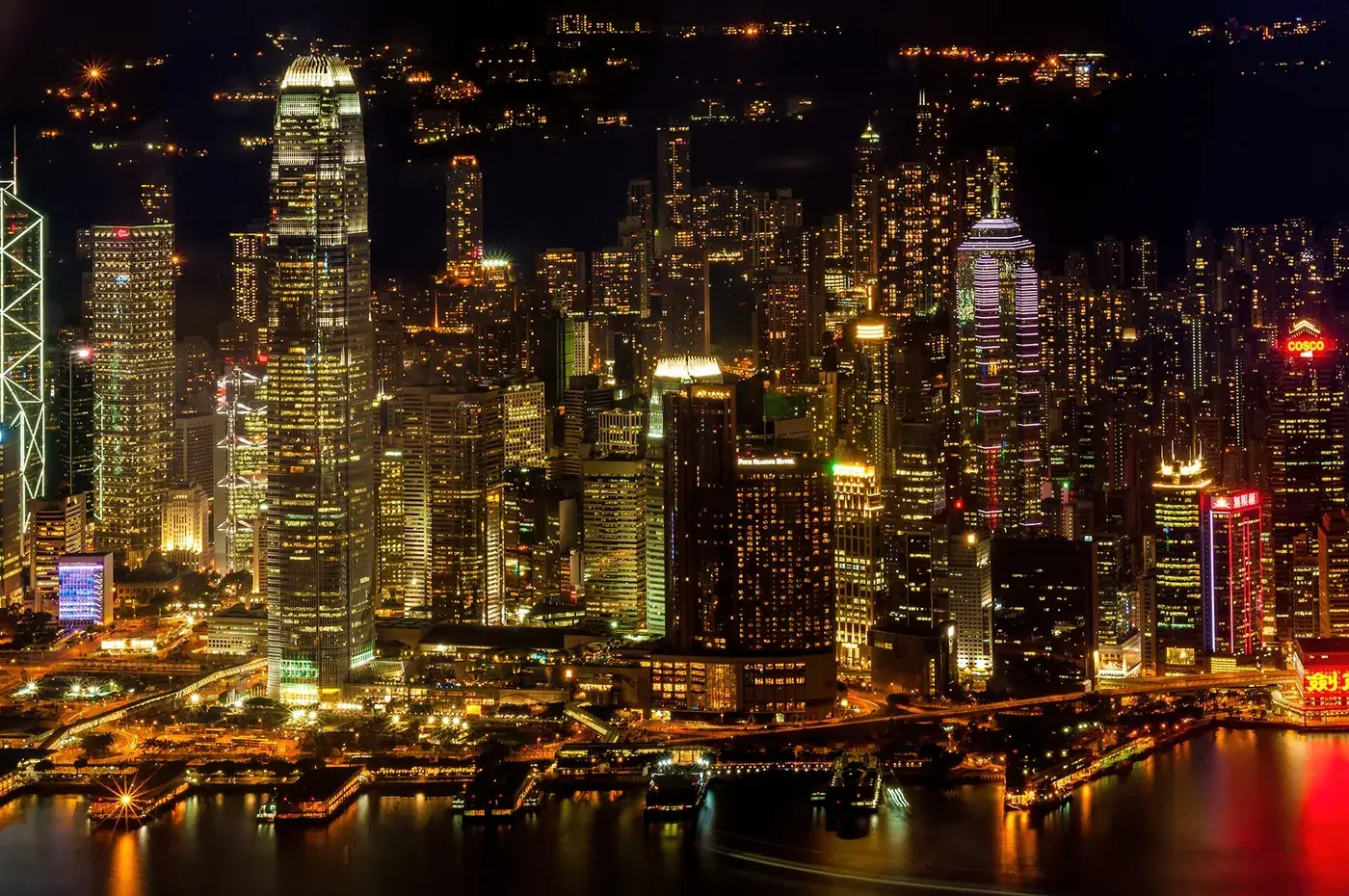 Hong Kong Island skyscrapers illuminated beside Victoria Harbour